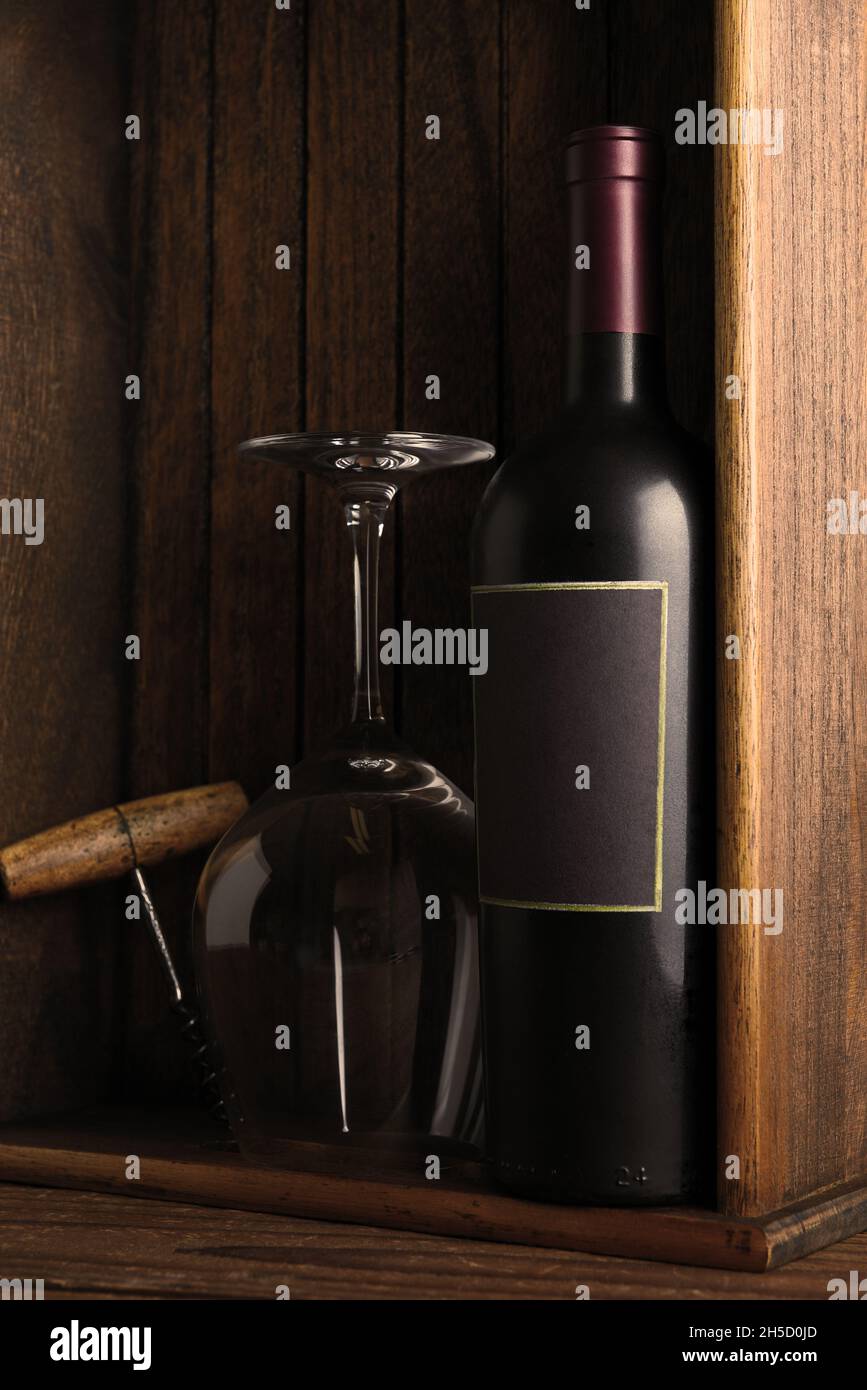 Stillleben Im Wein. Rotwein Flasche ein Weinglas und Korkenzieher in einer Holzkiste. Vertikal mit Kopierbereich. Stockfoto