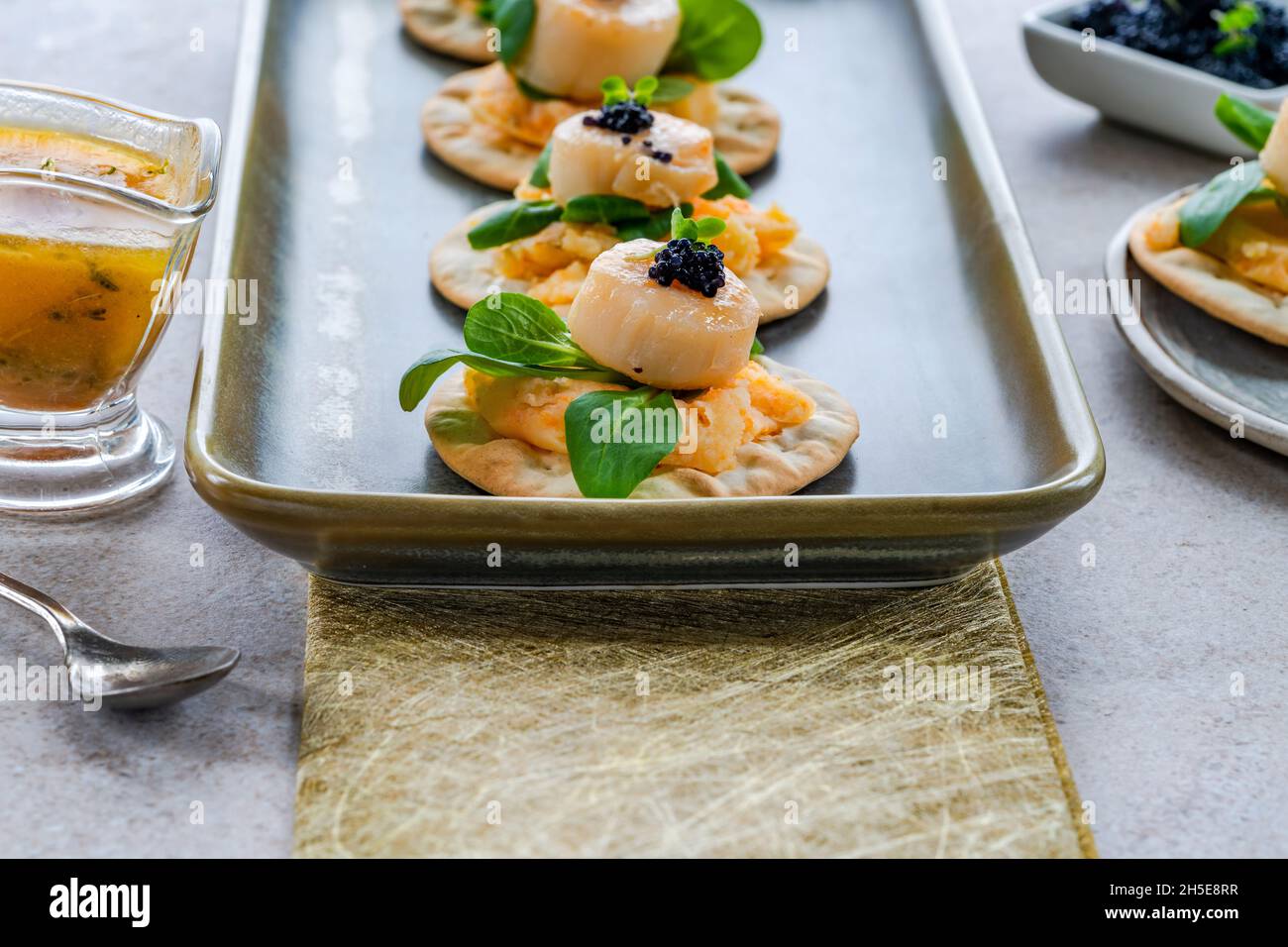 Kanapees mit Jakobsmuscheln, Kaviar und Limetten- und Buttersauce ...