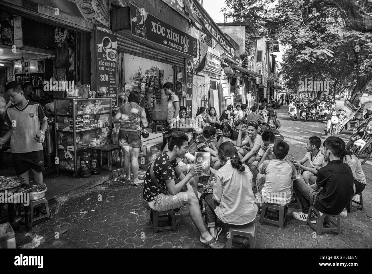 Erfrischungen im Freien in einem Straßencafé auf Lý Thường Kiệt, Hoàn Kiếm, Hanoi, Vietnam. Schwarz-Weiß-Version. Stockfoto