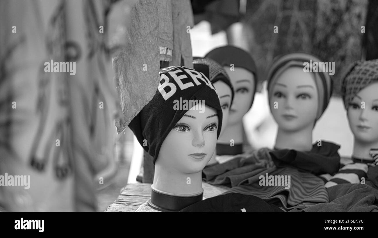 Schaufensterpuppe Kopf mit berliner Mütze auf einem Wochenmarkt in schwarz weiß. Flohmärkte mit Textilverkauf in berlin Stockfoto