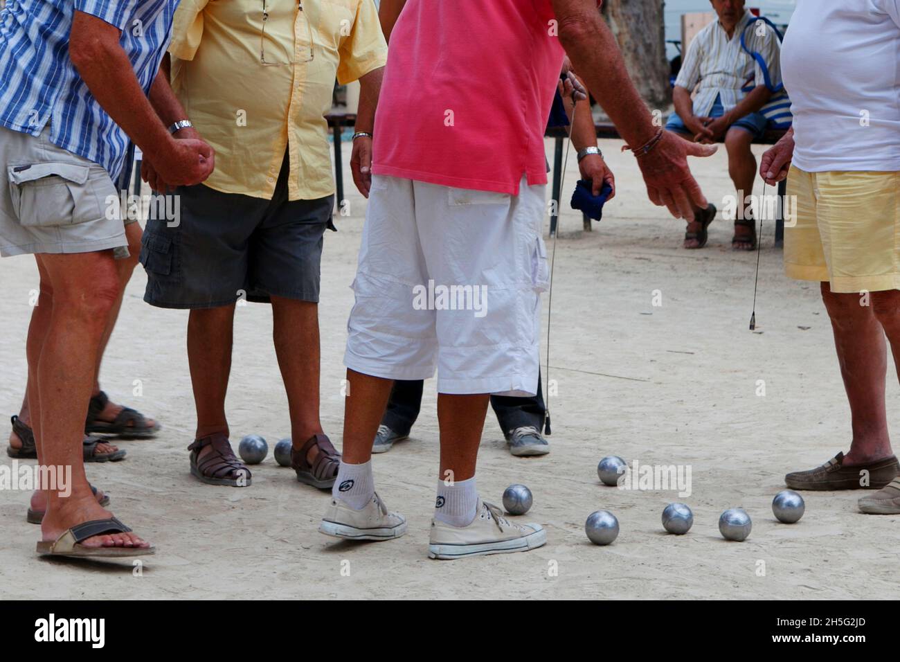 Franzosen, die gerade -auf einem öffentlichen Platz- Boule spielen. Keine Erkennbarkeit, da nur Beine. Cannes, Frankreich. Stockfoto