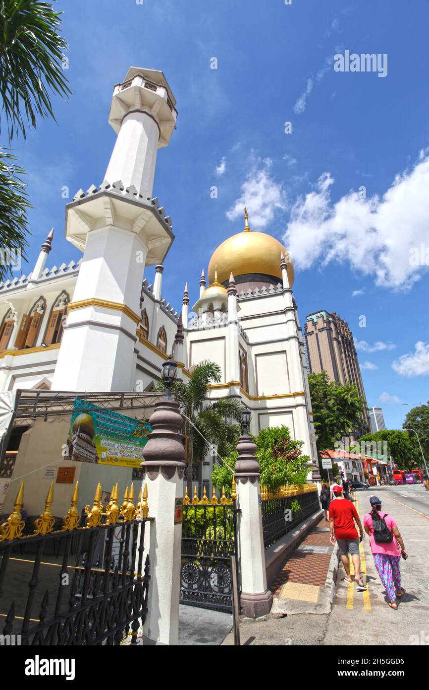 Seitenansicht der Sultan-Moschee oder Masjid Sultan und North Bridge Road mit Menschen, die auf dem Bürgersteig im Kampong Glam-Viertel von Singapur spazieren. Stockfoto