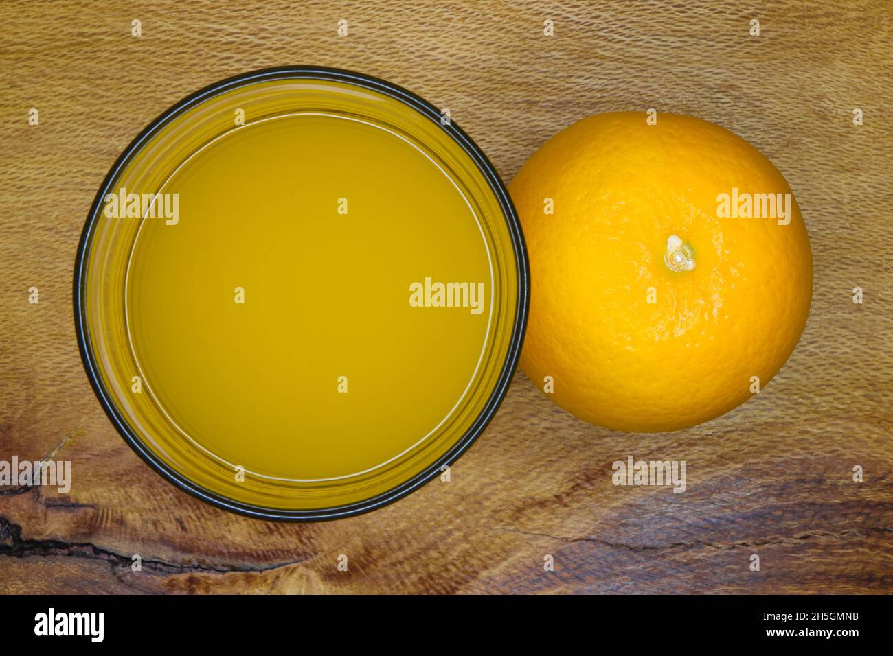 Valencia Orange mit Glas Saft Draufsicht auf Holz (Citrus x sinensis) Stockfoto