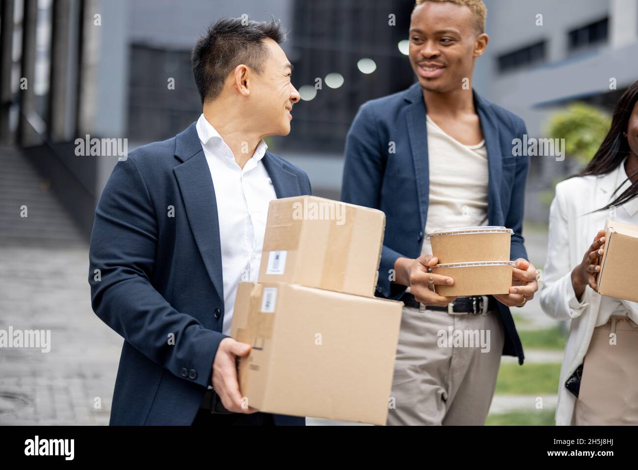 Businessdampf mit Paketen und Essen zu Fuß in der Stadt Stockfoto