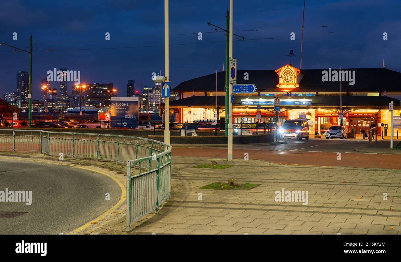 Woodside Ferry Village, Birkenhead, immer noch der eigentliche Fährterminal sowie ein modernes Lebensmittelgeschäft, mit der Skyline von Liverpool in der Ferne. Stockfoto