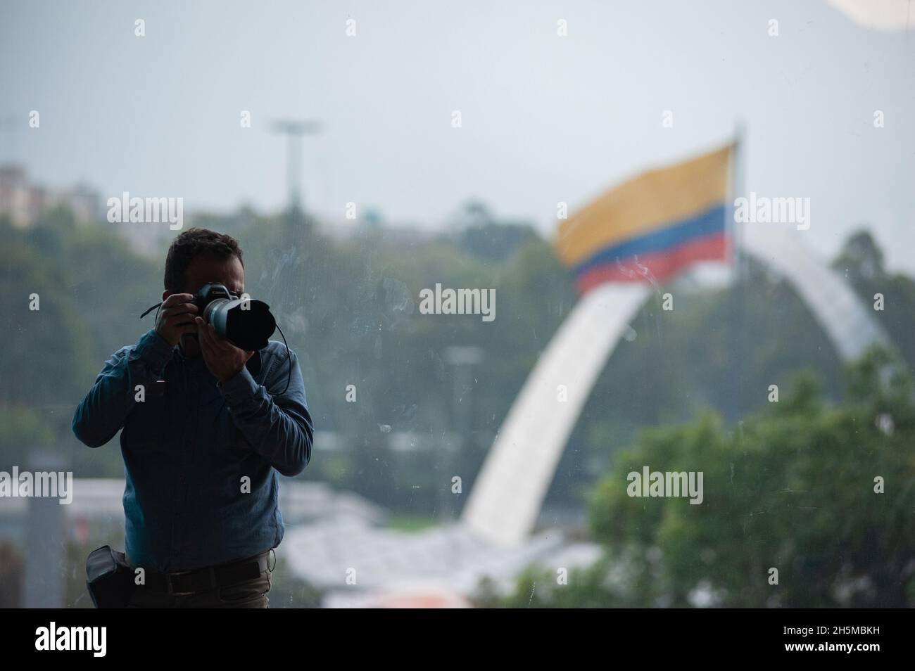 Während der Ankündigung der Einladung der südkoreanischen Regierung zur internationalen Buchmesse „Filbo“ in Bogota am 10. November 2021 durch das kolumbianische Kulturministerium wird ein Fotograf gesehen, der ein Foto mit der kolumbianischen Flagge auf der Rückseite auffängt. An der Veranstaltung nehmen die Botschafterin von Südkorea Choo Jong-Youn, der Präsident der Buchkammer Kolumbiens Enrique Gonzalez und die kolumbianische Kulturministerin Angelica Maria Moyolo Teil. Stockfoto