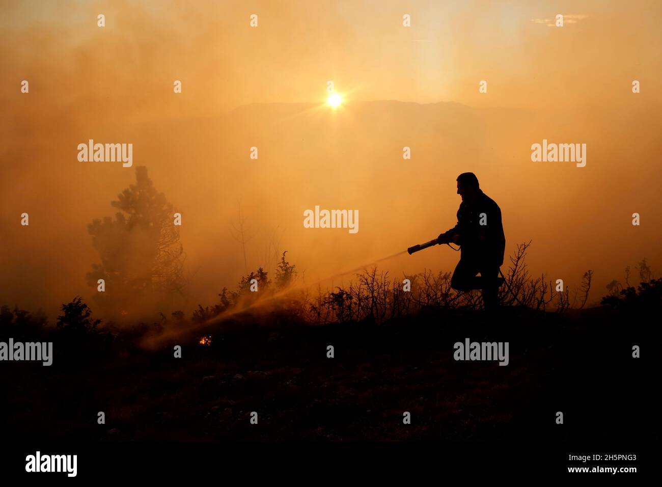 Der bosnische Feuerwehrmann arbeitet am Sonntag, den 11. Dezember 2016, daran, einen Waldbrand auf dem Berg Trebevic in der Nähe von Sarajevo, Bosnien, zu löschen. Waldbrandgeschwindigkeit Stockfoto