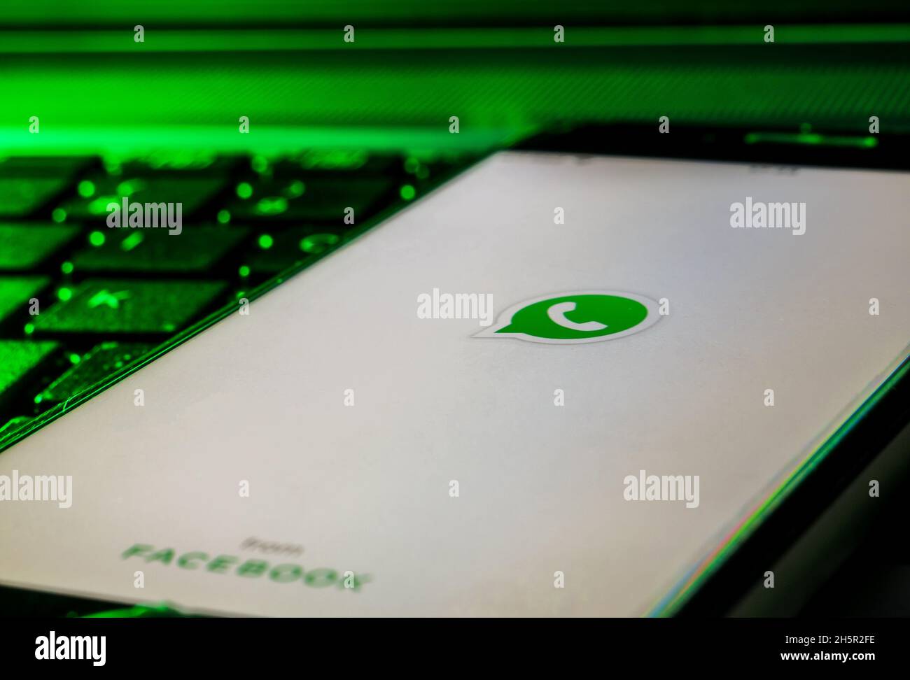 Smartphone auf einer Computertastatur mit dem Whatsapp App Logo Stockfoto