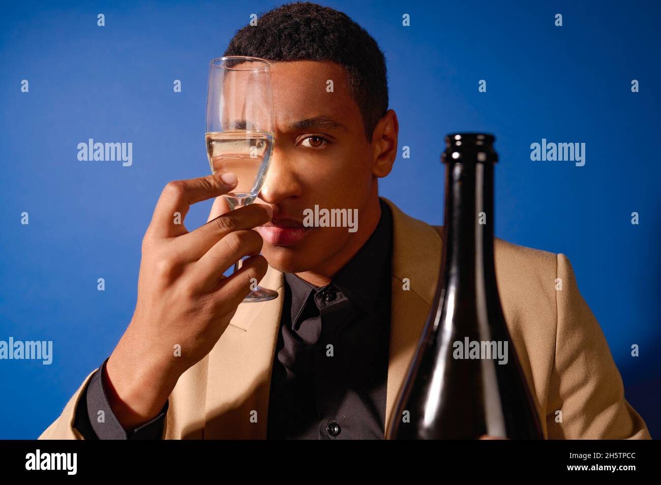 Ein gut aussehender junger Mann mit einem Glas Champagner Stockfoto