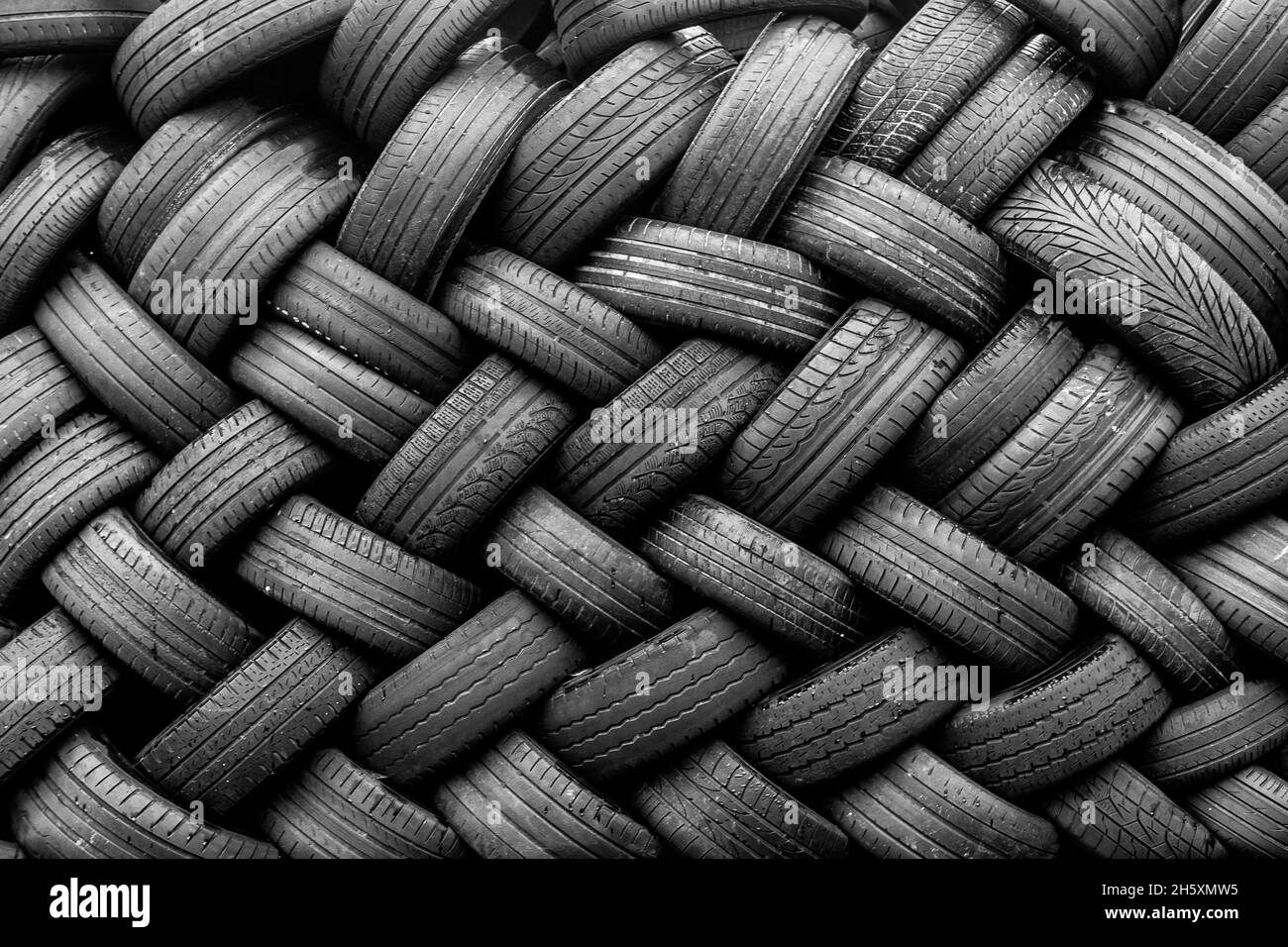 Alte Gebrauchtwagenreifen. Ein Haufen schwarzer Reifen, abstrakter Hintergrund. Stockfoto