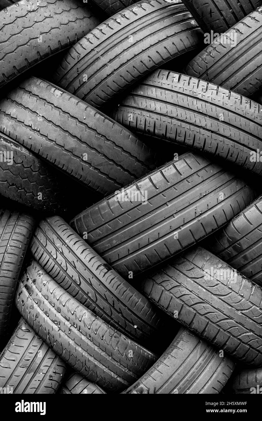 Alte Gebrauchtwagenreifen. Ein Haufen schwarzer Reifen, abstrakter Hintergrund. Stockfoto