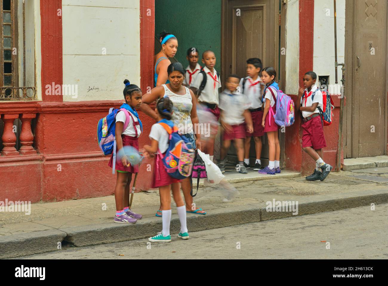 Straßenszene im Zentrum von Havanna. Schulkinder kommen an einer Stadtschule an, La Habana (Havanna), Habana, Kuba Stockfoto
