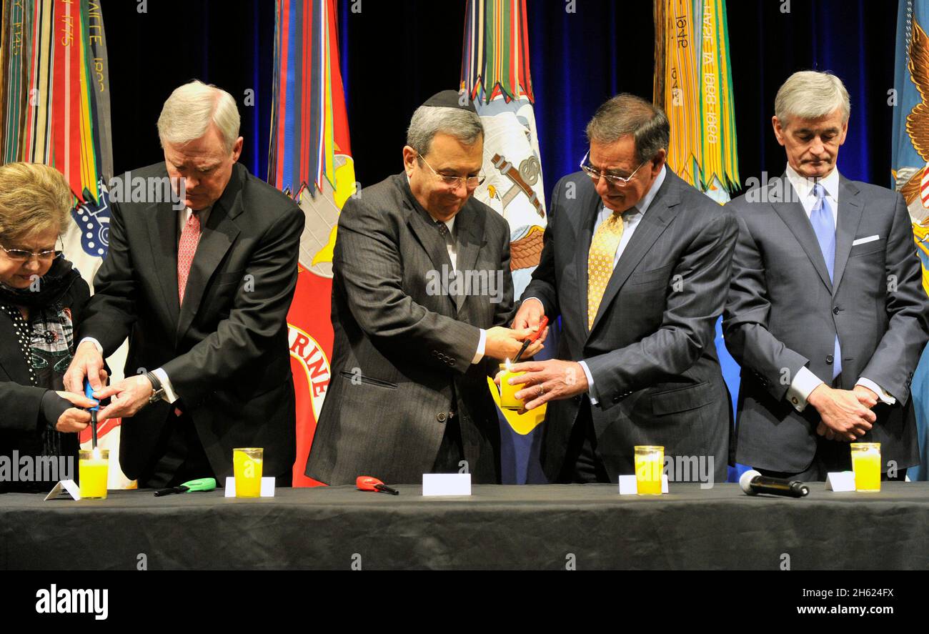 Verteidigungsminister Leon Panetta unterstützt die israelische Verteidigung Ehud Barak, während sie während einer Holocaust-Gedenkfeier, die am Donnerstag, dem 19. April 2012, im Pentagon Auditorium stattfand, Kerzen anzünden. Stockfoto