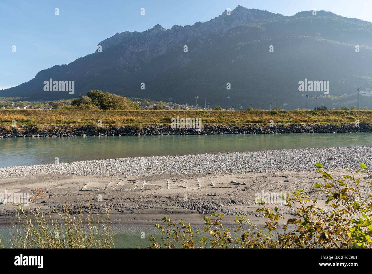Sevelen, Schweiz, 11. Oktober 2021 Freiheit auf französisch geschrieben mit Steinen auf einer Sandbank am rhein Stockfoto
