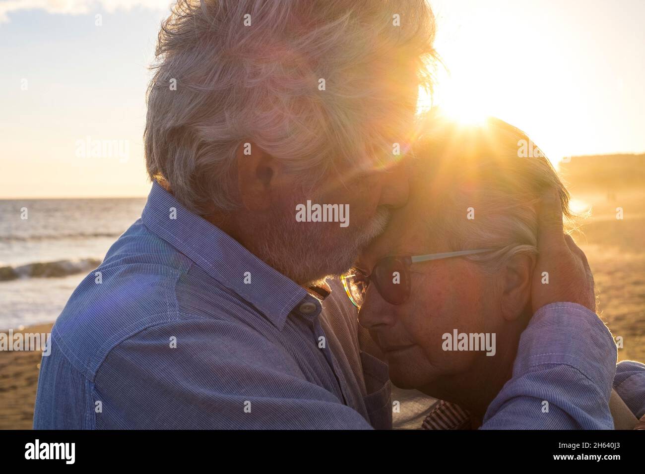 Porträt von zwei glücklichen Senioren und reifen und alten Menschen am Strand zusammen. Rentner und Rentner Mann trösten traurig depressiv Frau weinen. Stockfoto