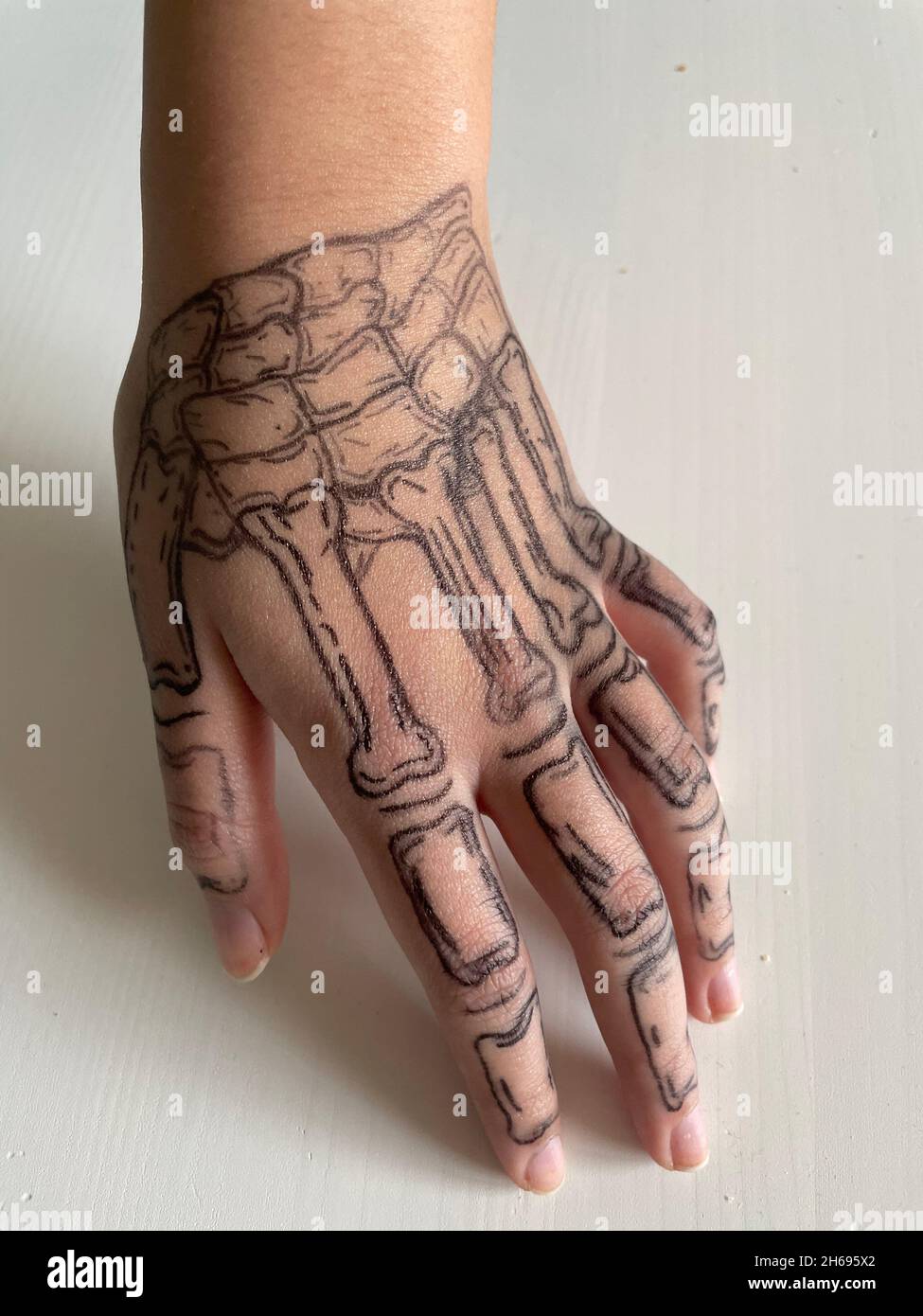 Skelettzeichnung auf der Hand der Frau.Coco Skeleton Hände temporäre Tattoos für Cosplay. Schädel Stockfoto