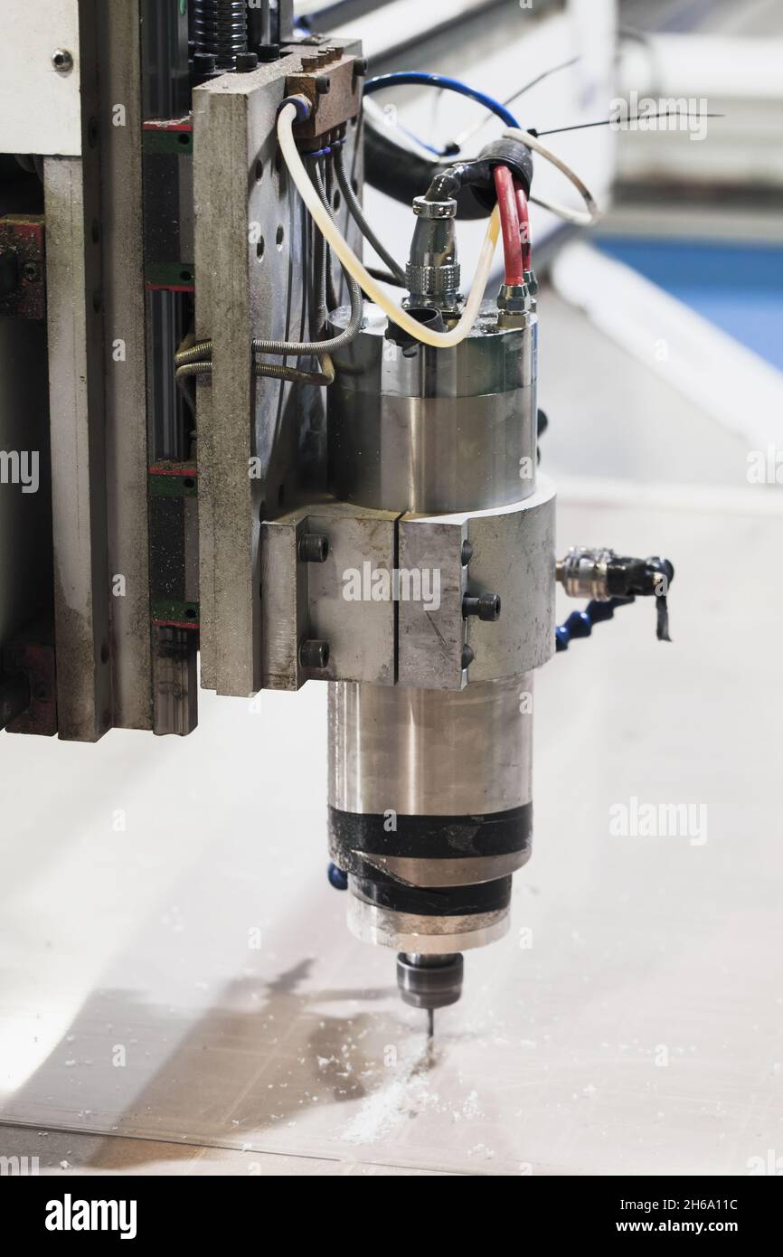 Endfräser verarbeitet Kunststoffblech auf einer CNC-Fräsmaschine. Automatische industrielle Werkzeug arbeitet Stockfoto