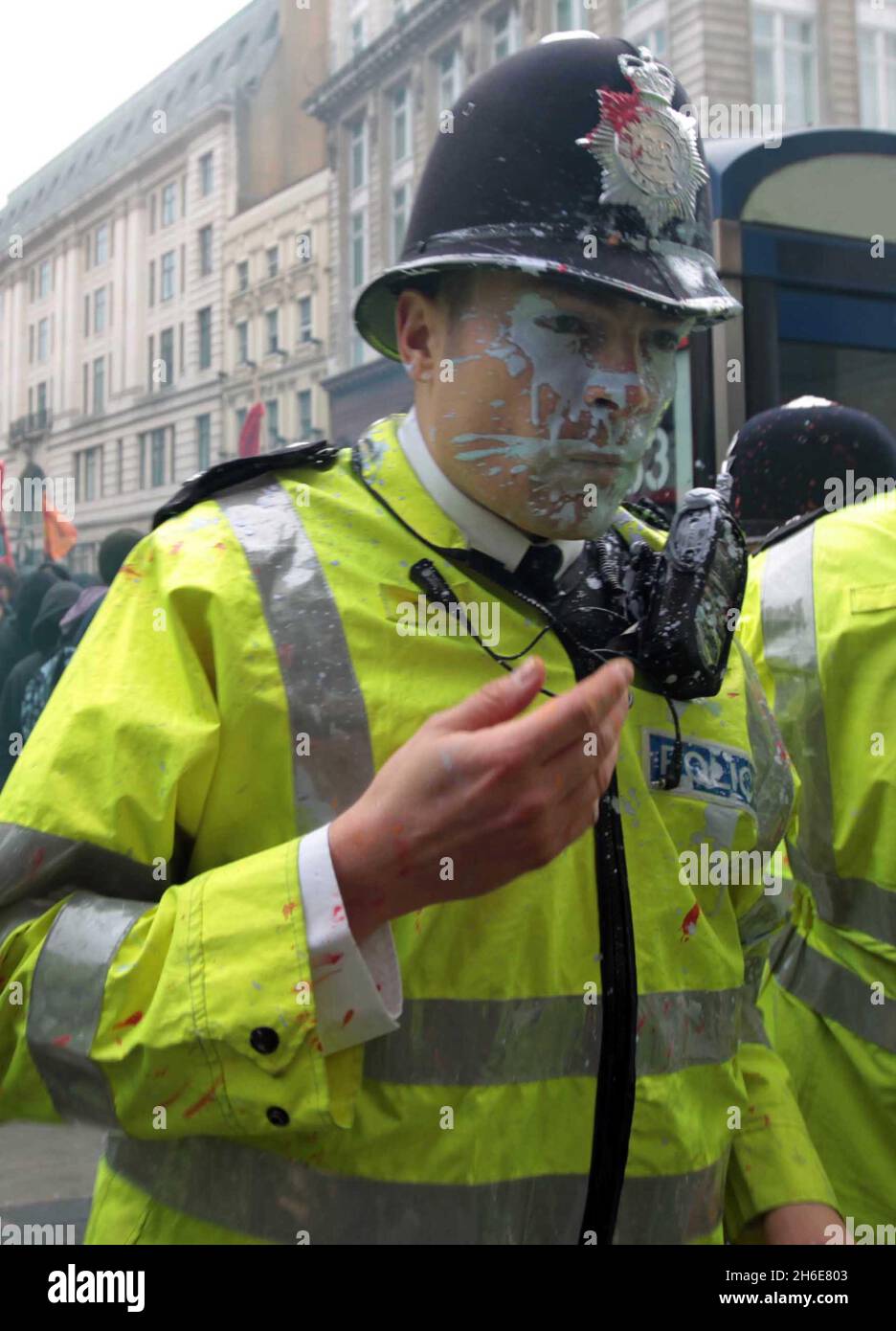 Während der TUC-Anti-Cuts-Demo im Zentrum von London wird ein Polizeibeamter von einer Farbbombe in der Oxford Street getroffen Stockfoto