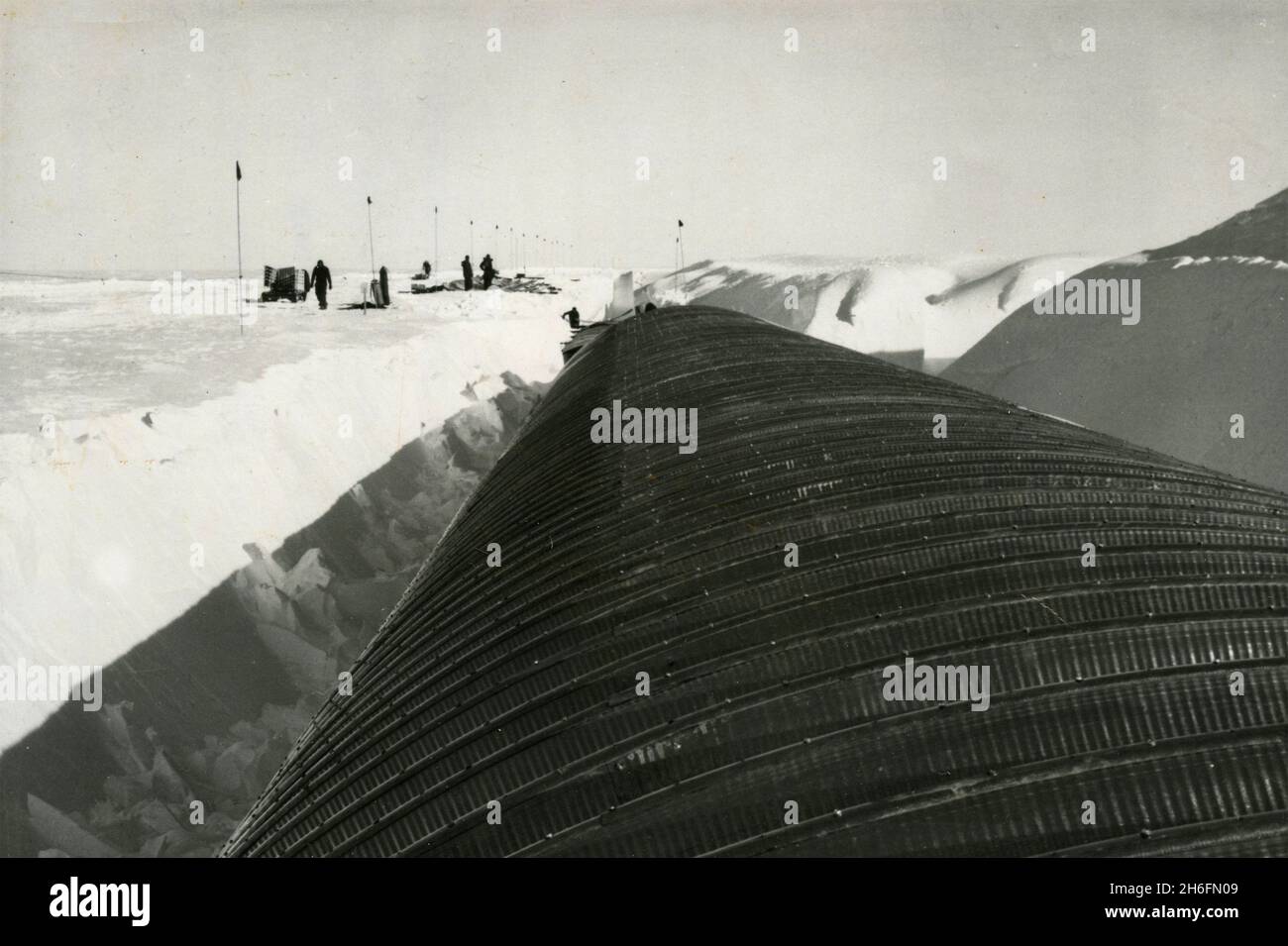 Bauansicht des Atomkraftwerks der New Byrd Station: Stahlbleche werden als Dach für den Tunnel, Antarctica 1962, befestigt Stockfoto
