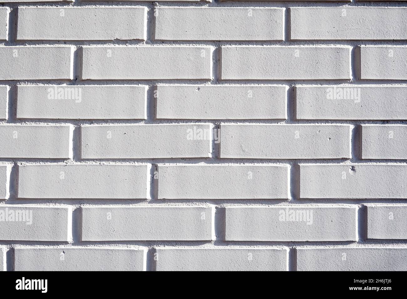 Weiß lackierte Ziegelwand Musterstruktur. Außenhintergründe des Gebäudes Stockfoto