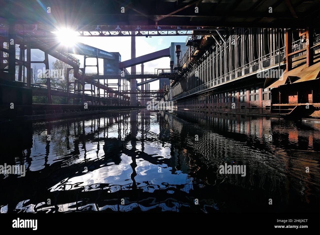 Deutschland, NRW, Essen, Zeche Zollverein; Reflexionen in der Wasseroberfläche neben der Kokerei. Stockfoto