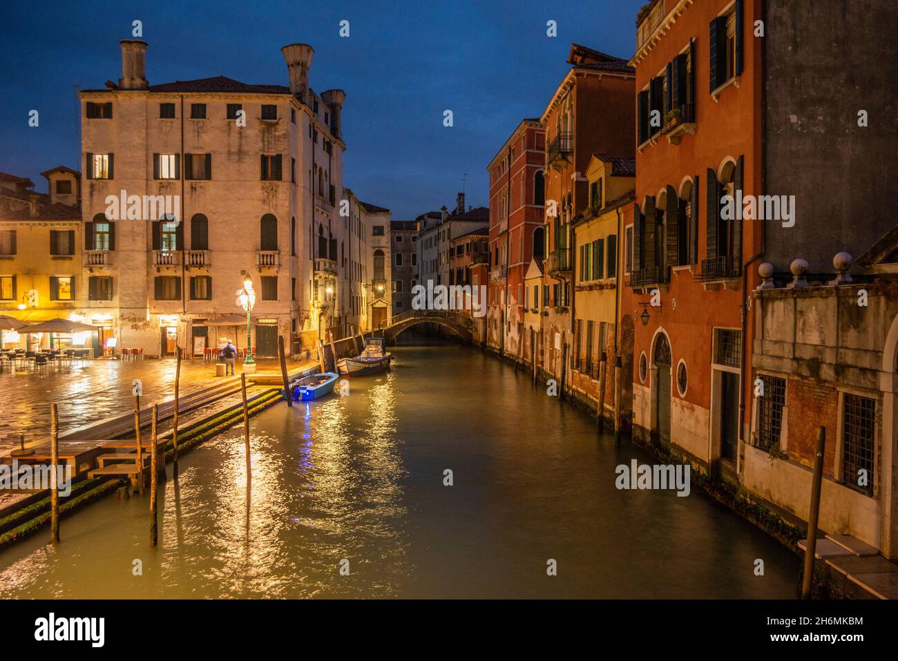 Blick in die Abenddämmerung auf die typisch venezianischen Kanäle oder Wasserstraßen, Italien. Stockfoto