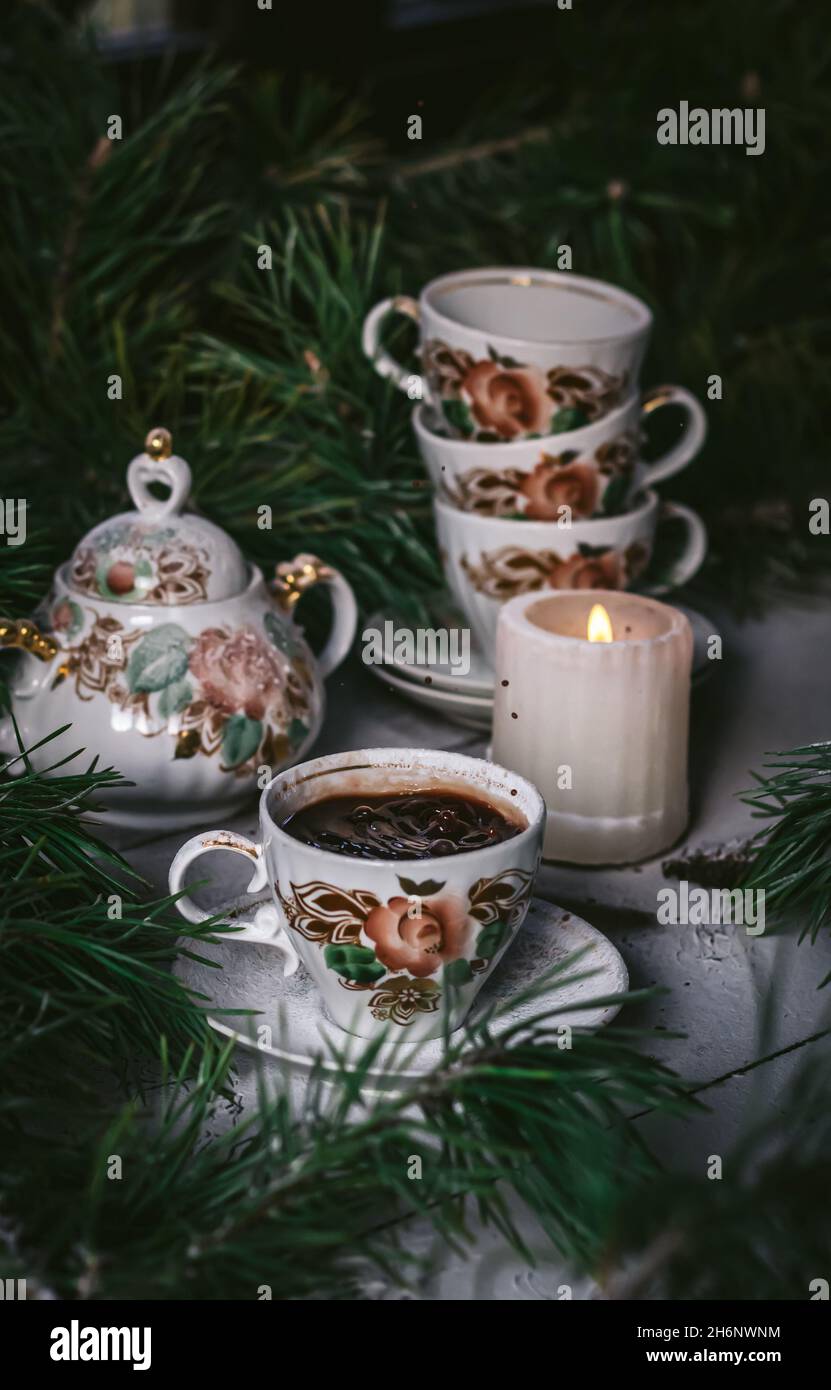 Eine Tasse heißen Kaffee auf einem verschneiten Tisch. Tasse Kaffee im Fokus Stockfoto