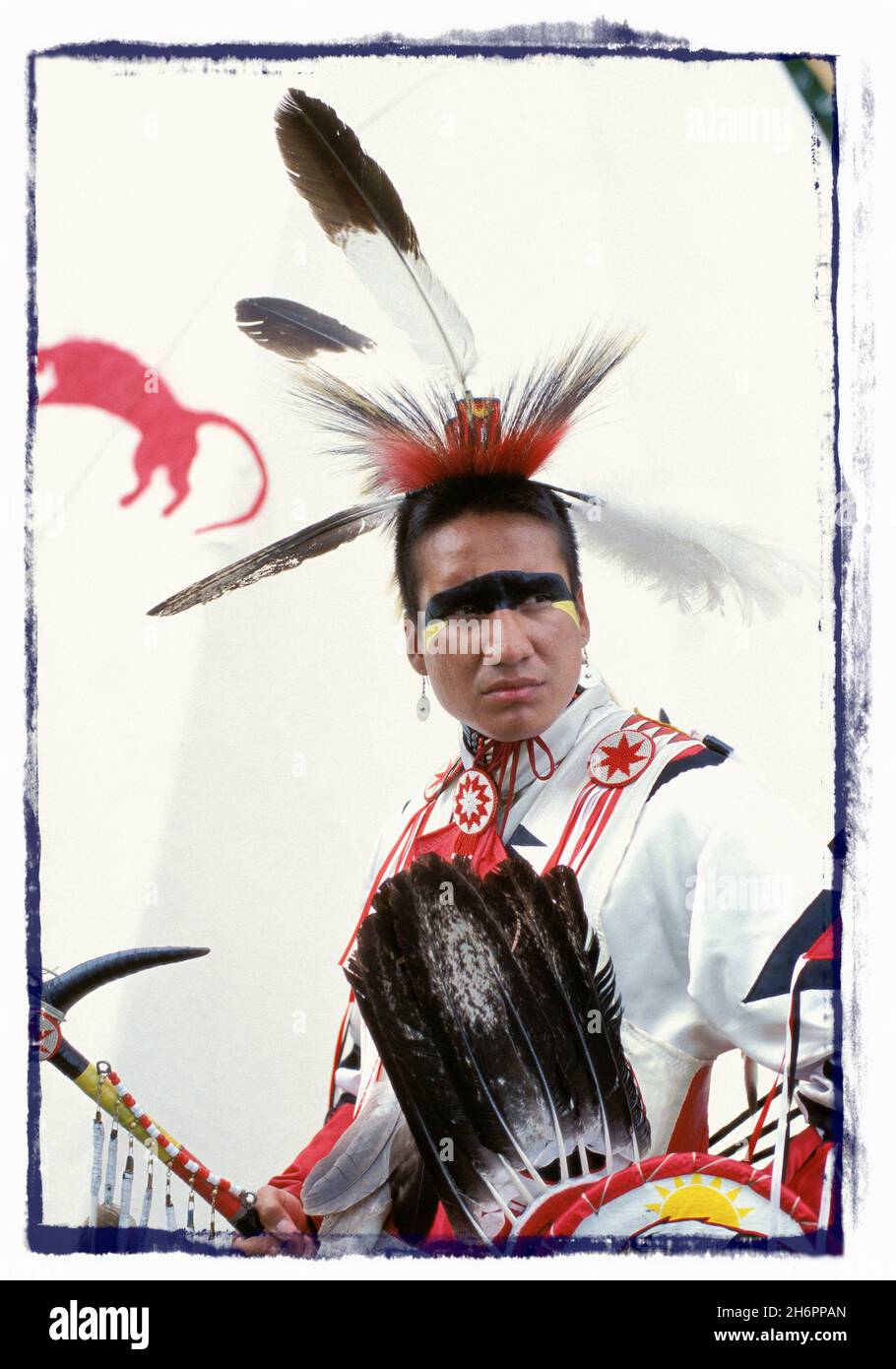 Porträt eines Indianers in traditioneller zeremonieller Kleidung, der vor einem Tipi steht Stockfoto