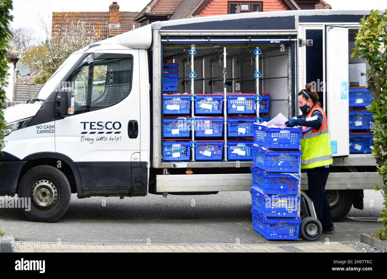 Frau Tesco Supermarkt Online-Shopping Lieferung van Fahrer trägt hohe Sichtbarkeit Personal Uniform Entladen Kundenauftrag außerhalb Haus England UK Stockfoto