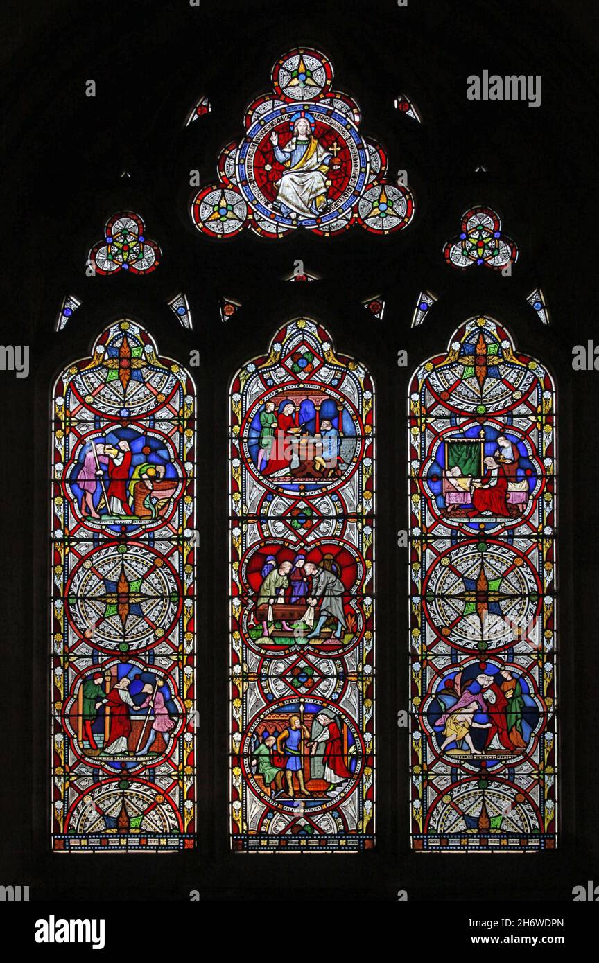 Ein Buntglasfenster von Clayton & Bell 1858 mit Werken der Barmherzigkeit, Holy Trinity Church, Blatherwycke , Northamptonshire; Designer J R Clayton. Stockfoto