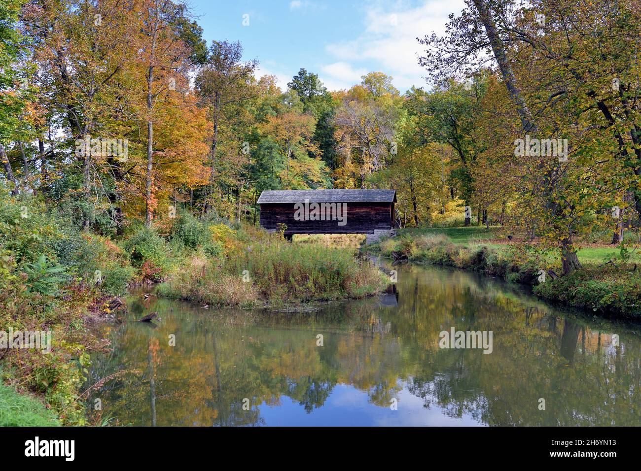 Cooperstown, New York, USA. Eine frühe Herbstansicht der Hyde Hall Covered Bridge über Shadow Brook. Die Brücke wurde 1825 gebaut. Stockfoto