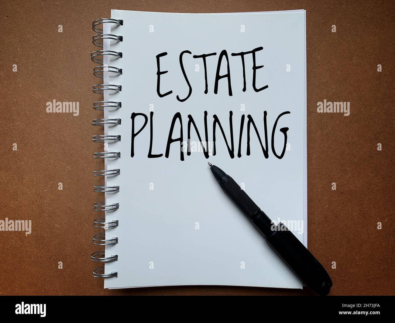 Text auf Notizblock mit Stift - Estate Planning Stockfoto