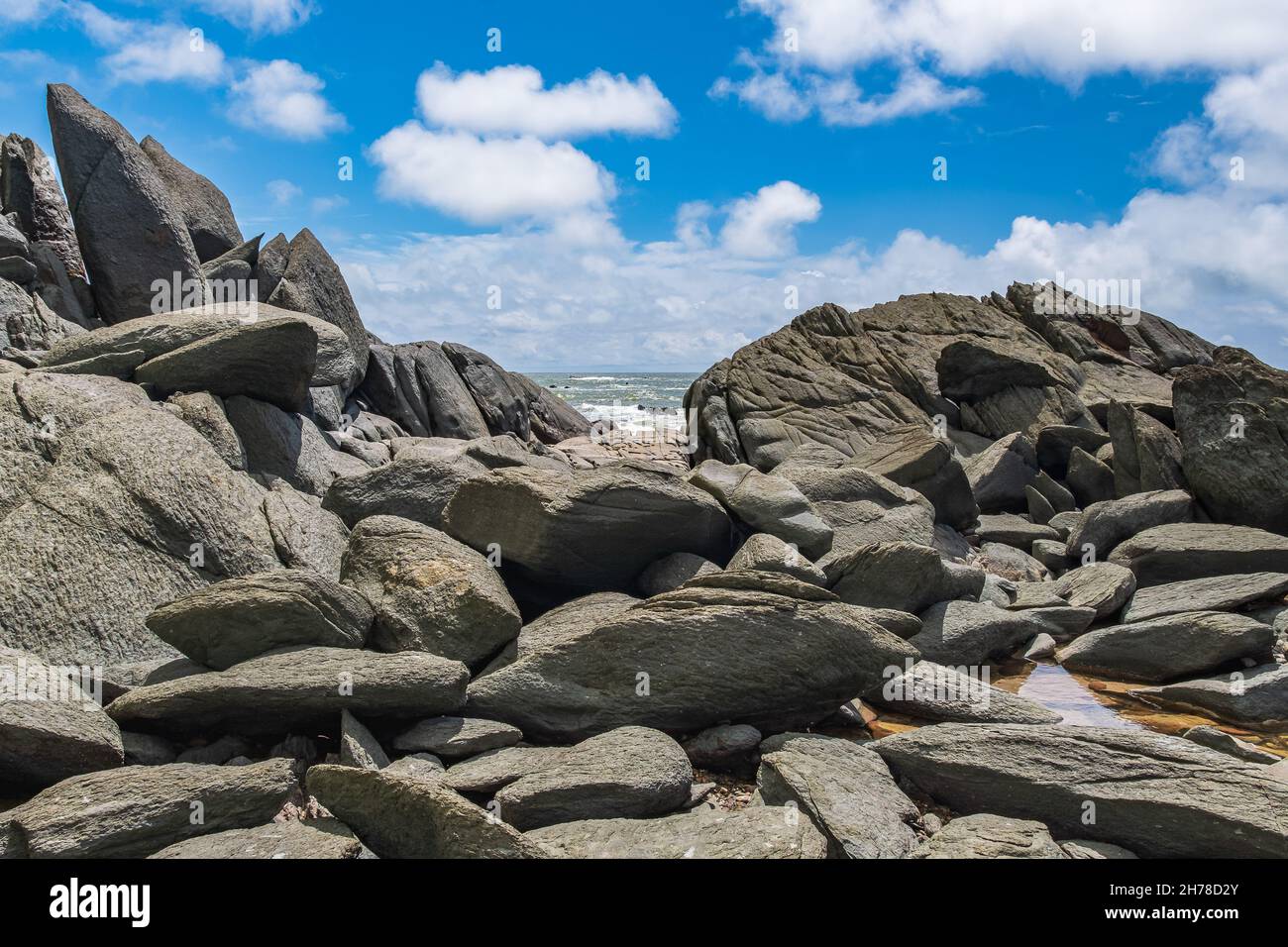 Natürliche große Felsbrocken liegen am Strand mit Blick auf das Meer in Axim Ghana Westafrika Stockfoto