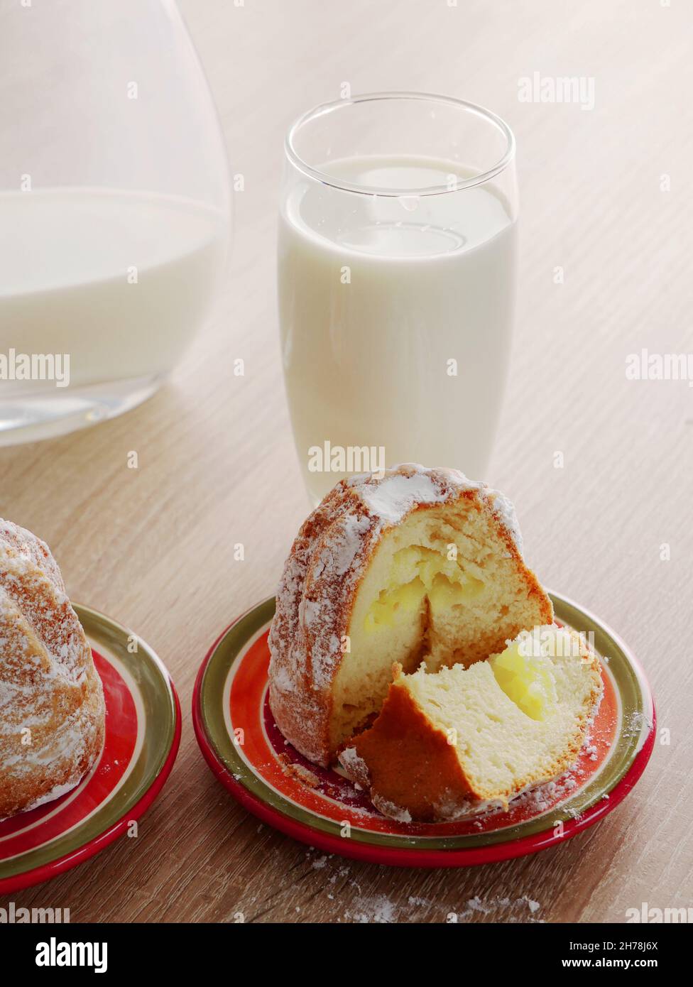 Süßer Hefe-Cupcake gefüllt mit Vanillecreme und frischer veganer Milch. Leckeres Frühstück. Hausgemachtes Gebäck. Stockfoto