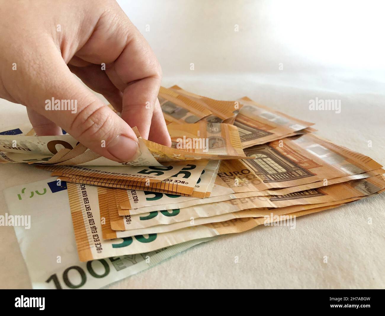 Hand und Banknoten, die einen Haufen Euro zählen Stockfoto