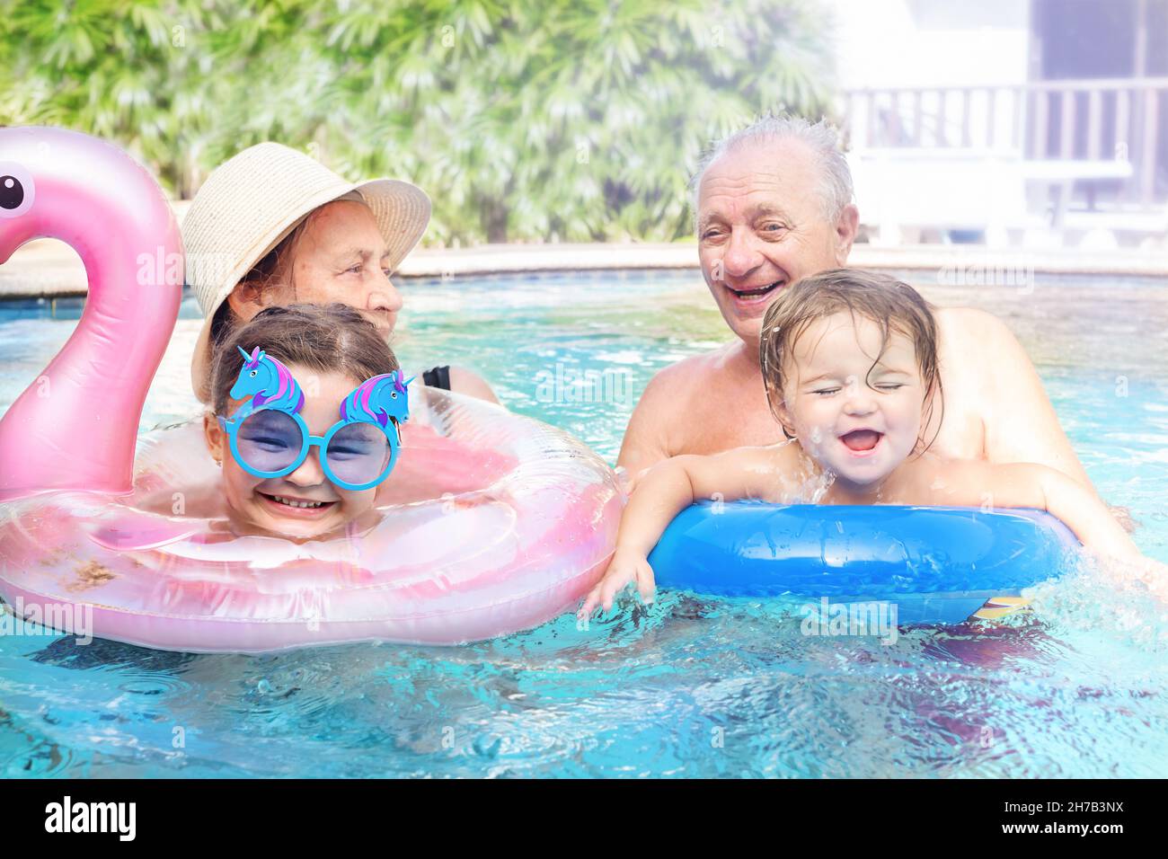 Porträt von Urgroßeltern mit Urenkeln im Urlaub. Aktive Rentner spielen