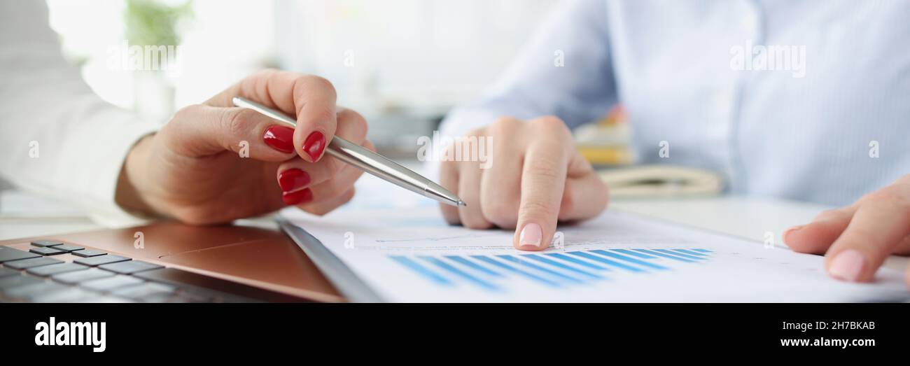 Weibliche Marketingfachleute, die in Geschäftsdiagrammen berichten Stockfoto