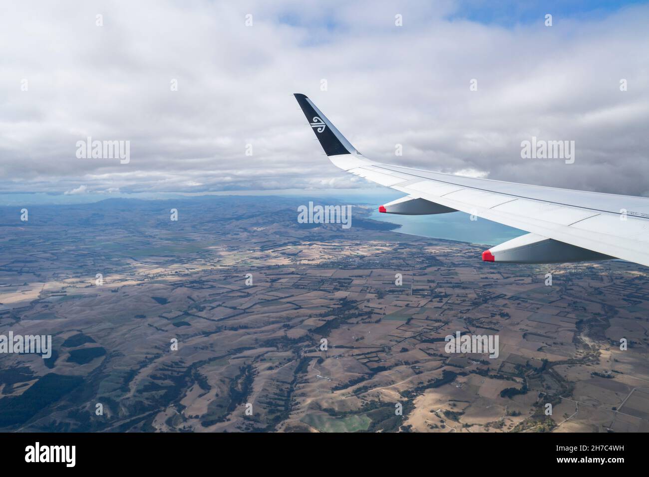 Luftaufnahme eines Flugzeugflügels mit Air New Zealand-Logo. Fliegen über Canterbury. Bild aufgenommen auf dem Air NZ Flug von Auckland nach Christchurch. Stockfoto