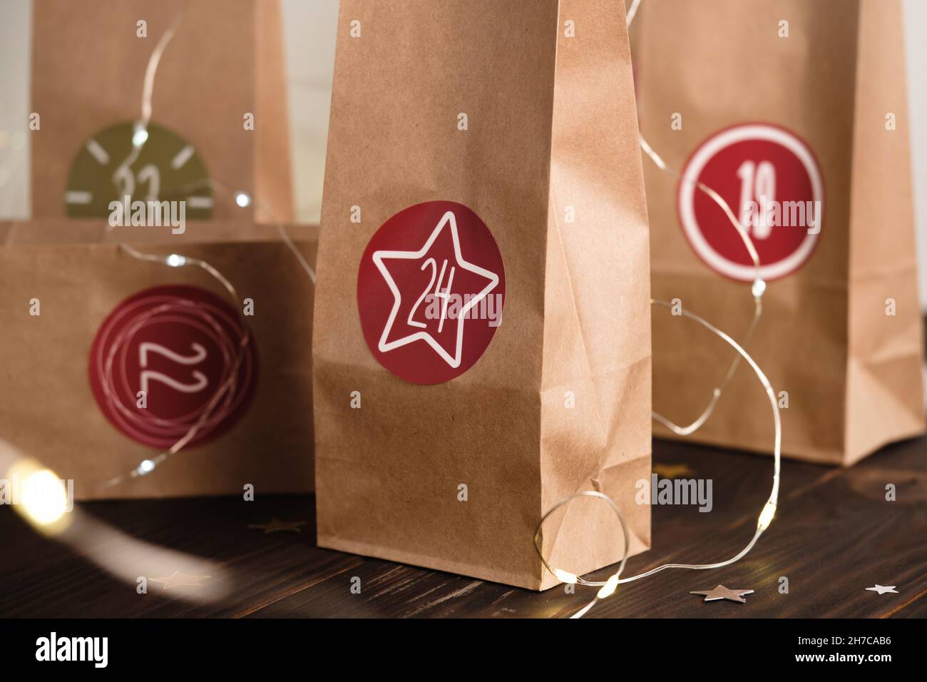 Weihnachts-Adventskalender für Kinder, kreative Aufgaben in Papiertüten für den Alltag. 24 handgefertigte nummerierte Taschen mit Geschenken. Countdown bis Heiligabend. Schließen Stockfoto