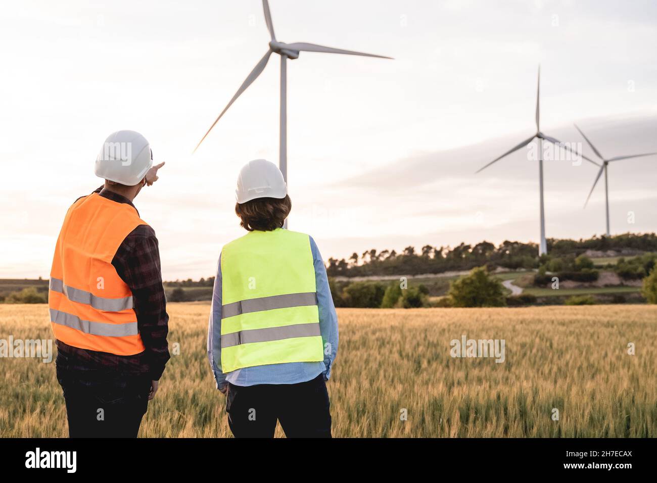 Nachhaltige Energiewirtschaft - Ingenieure, die in einem alternativen erneuerbaren Windpark arbeiten Stockfoto