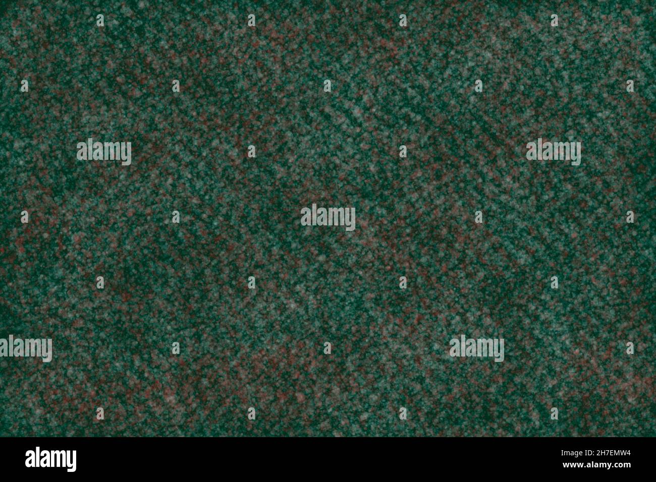 Abstrakte Textur, bestehend aus einem grünen Hintergrund mit weißen und roten Flecken. Stockfoto