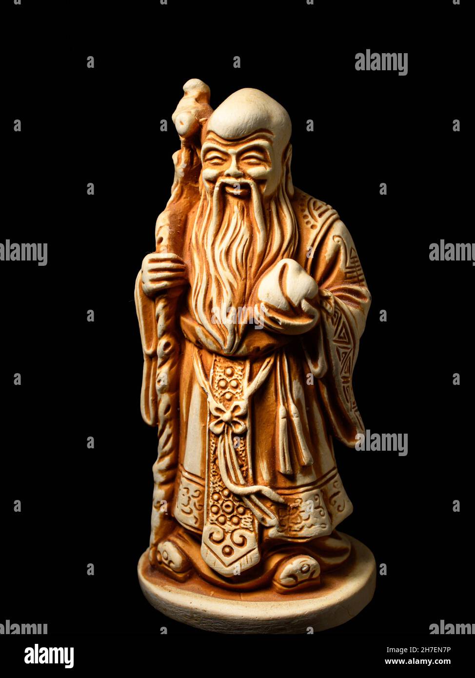 Makro einer kleinen Figur des gottes Shu (einer der drei Sterne Ältesten). Shu ist der gott der Langlebigkeit, Gesundheit und Unsterblichkeit - mit einem Pfirsich in der Hand Stockfoto