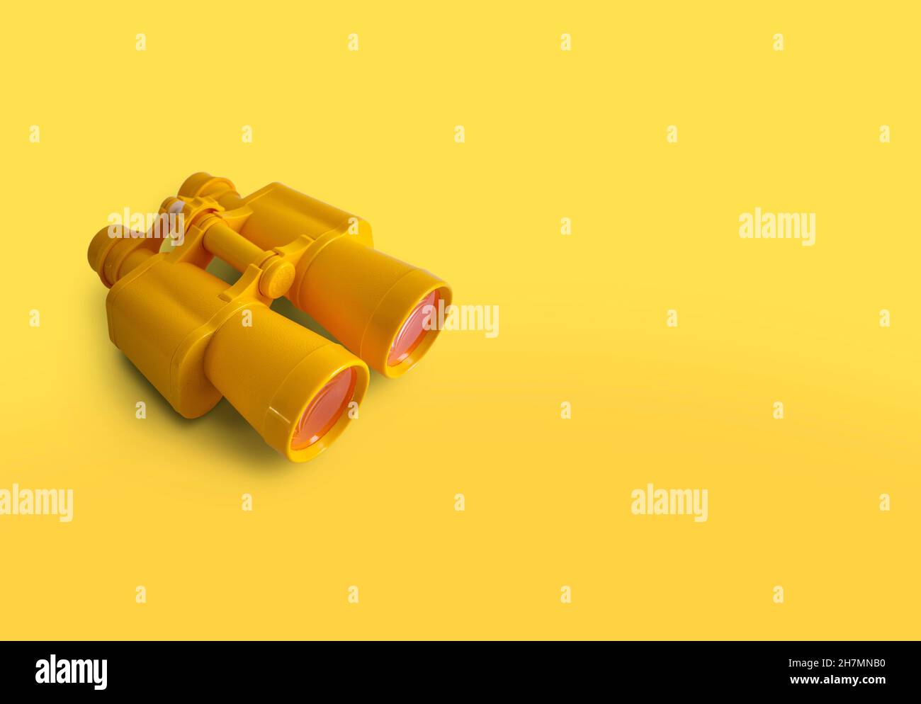Gelbes Fernglas isoliert auf gelbem Hintergrund mit Kopierraum Stockfoto