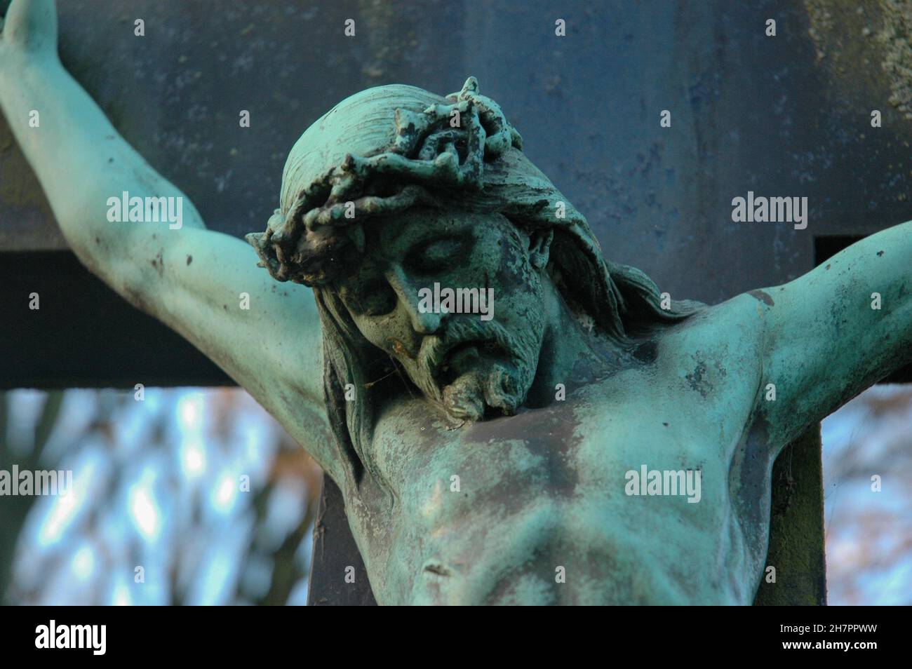 Alte Statue von Jesus, die mit der Dornenkrone am Kreuz genagelt wurde Stockfoto