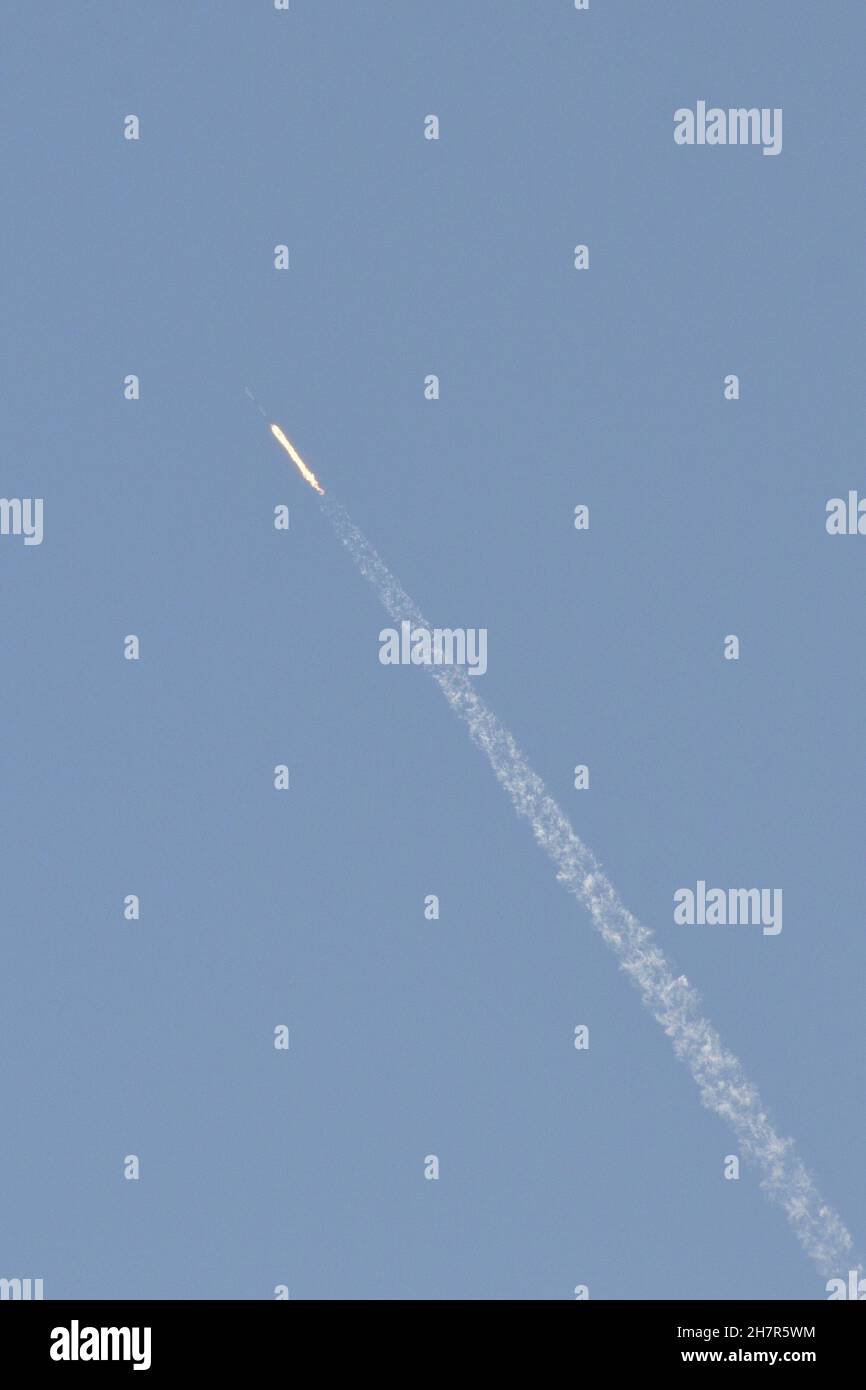 Eine SpaceX Falcon 9 Rakete mit brennendem Brennstoff und einem Kondensstreifen. Stockfoto
