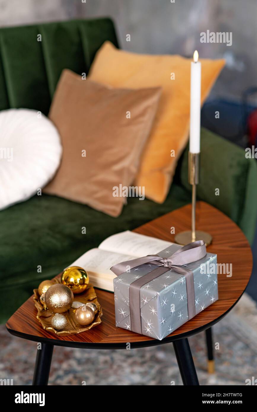 Weihnachten und Neujahr Hintergrund - Geschenkboxen, Geschenke, Kerzen, auf dem Tisch im Loft-Innenraum. Weicher, selektiver Fokus. Stockfoto