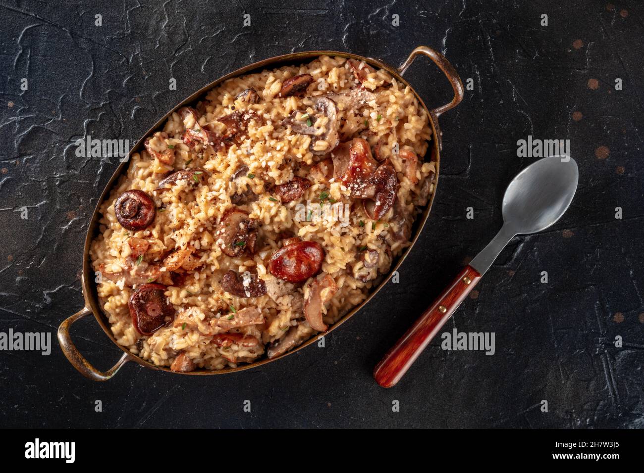 Risotto ai funghi, Pilzreis, oben auf schwarzem Schiefergrund geschossen Stockfoto