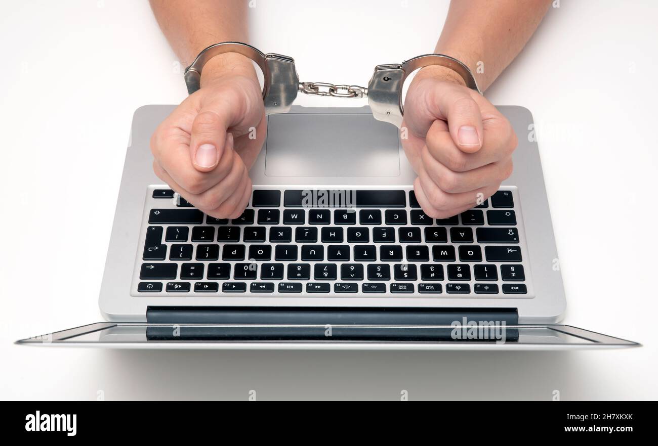 Konzept der Cyberkriminalität mit Mann in Handschellen. Phishing-Angriff, Malware Stockfoto