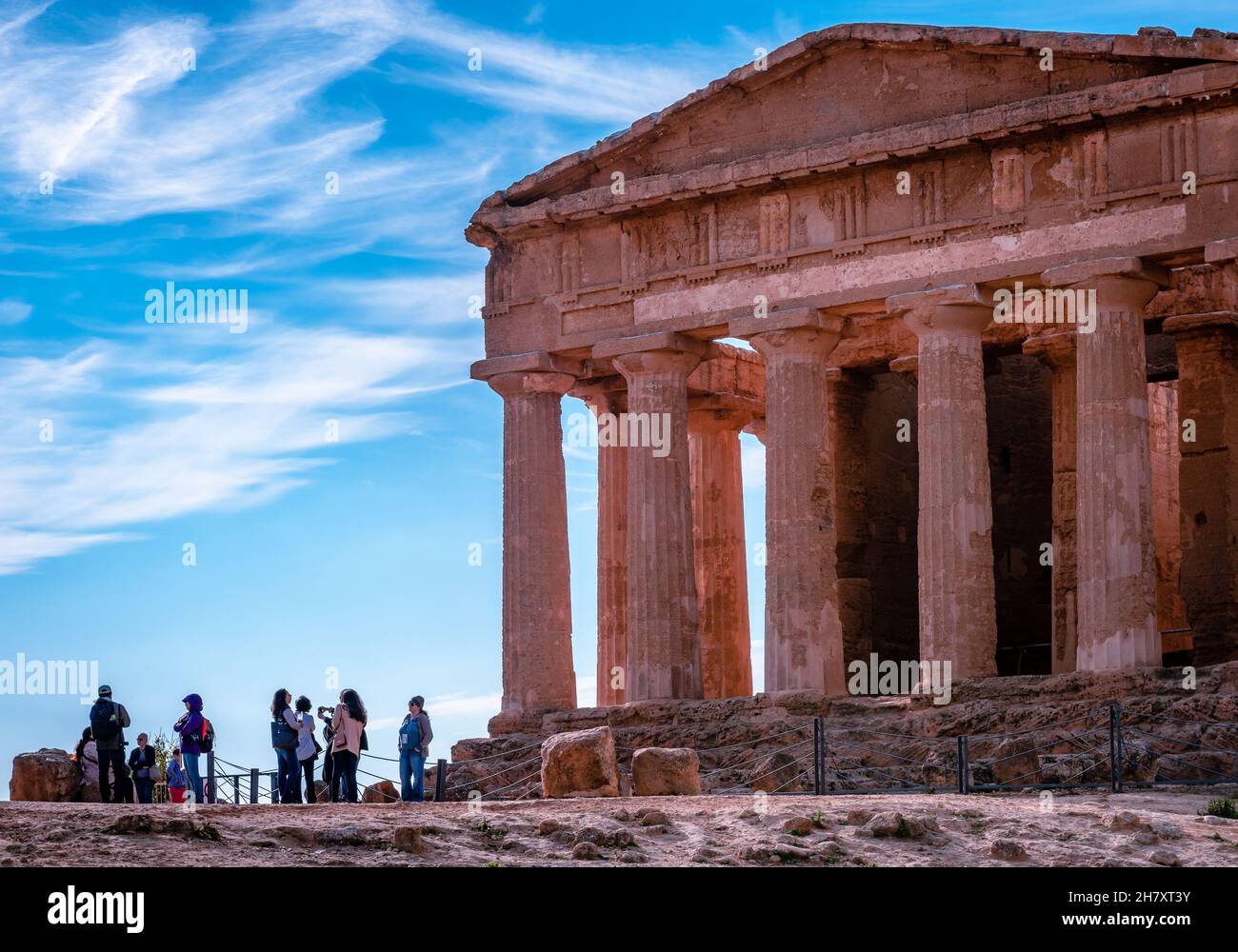 Touristen bewundern den Tempel der Concordia, einen antiken griechischen Tempel im Tal der Tempel, in Agrigento, Sizilien, Italien. Stockfoto