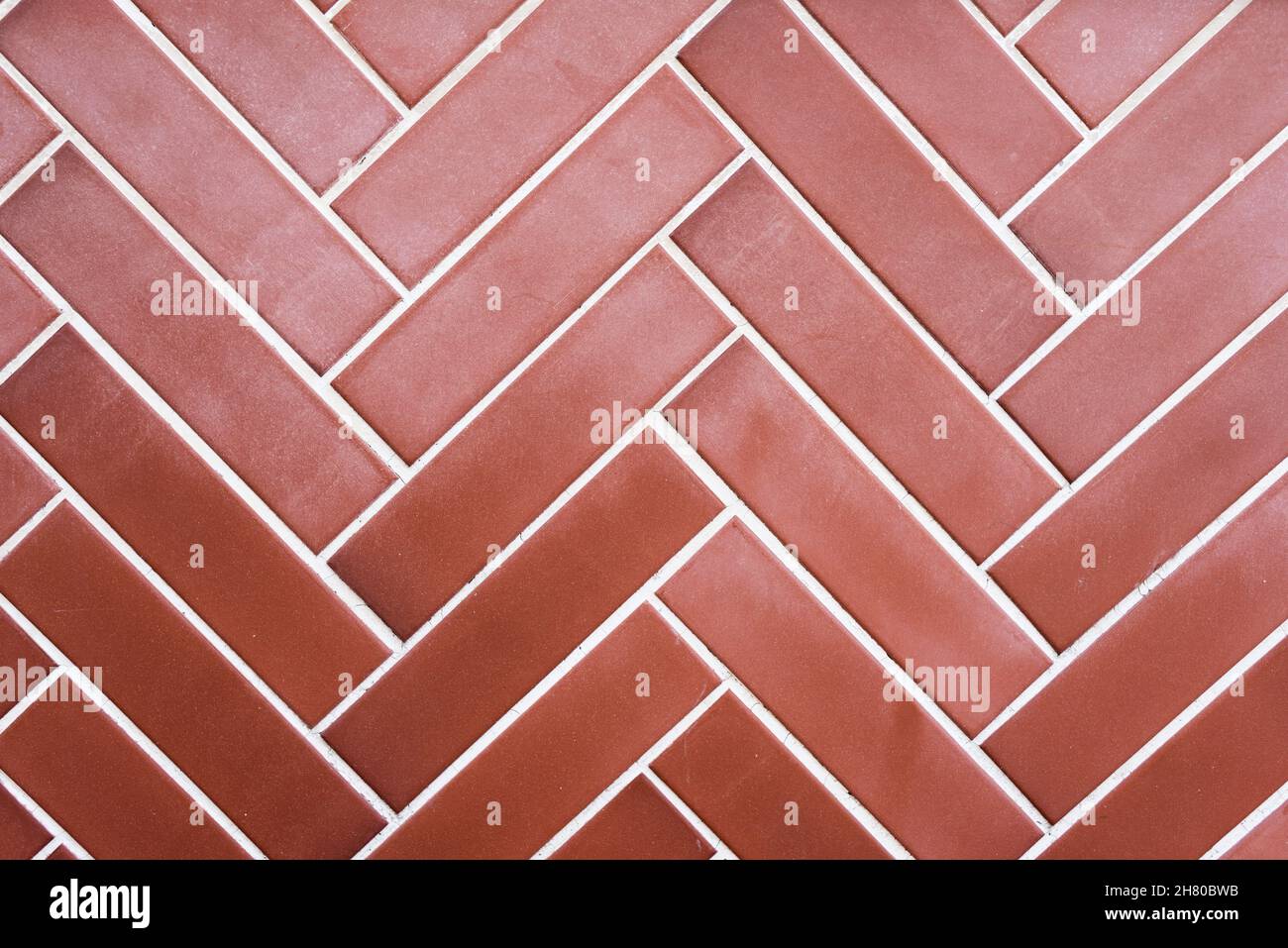 Texturierter Hintergrund einer Wand aus Ziegeln in einem diagonalen Muster platziert. Stockfoto